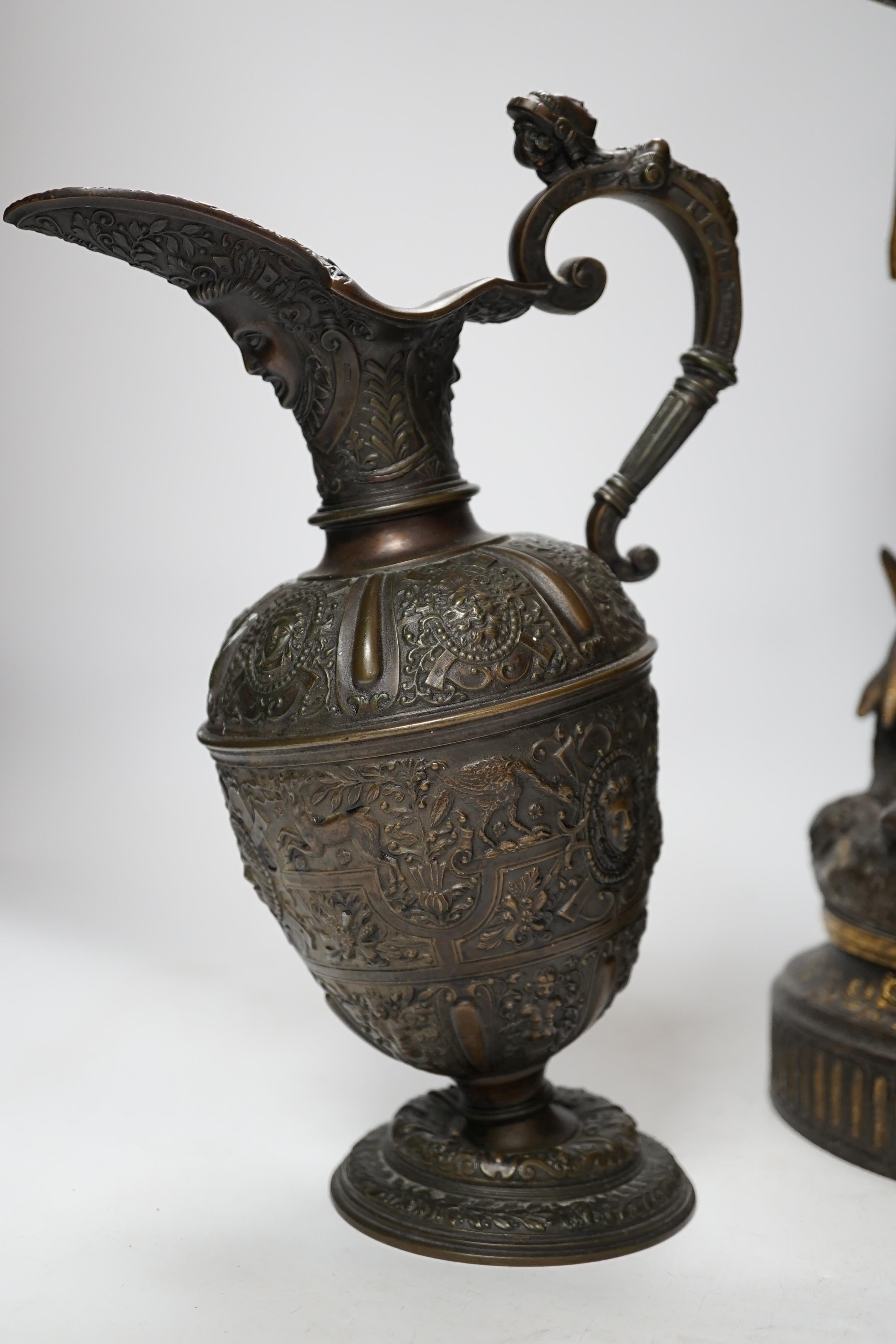 A 19th century parcel gilt and bronzed spelter figure of a cavalier, together with a Florentine style bronze ewer, 49cm high (the latter a.f.) (2)